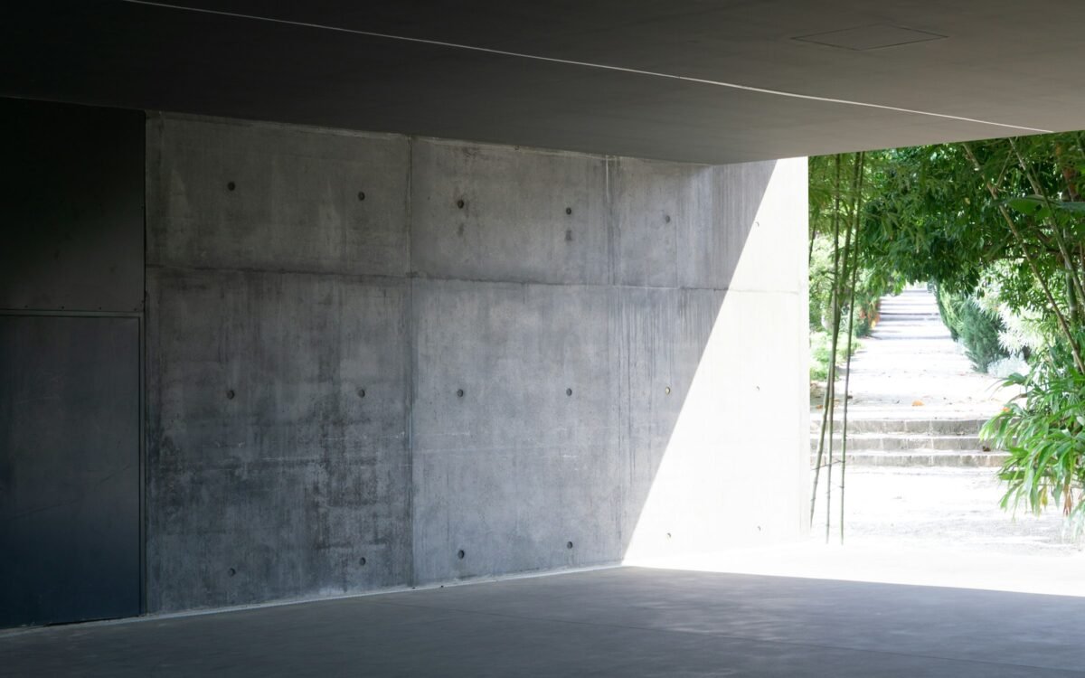 A bare grey industrial space after an exhibition has been taken down