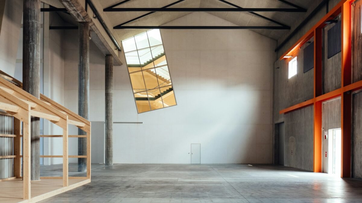 A bare concrete building interior standing empty before an exhibition is installed