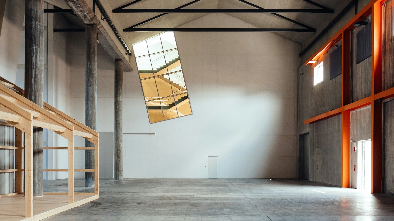 A bare concrete building interior standing empty before an exhibition is installed